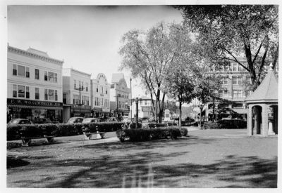 Sanford Square
View of the square from Willard Park, 1939. This lovely park once boasted elegant street lamps and a gazebo with a drinking fountain. When the town decided to remove the latter, Hazen Carpenter saved the roof and it now graces a replica of the gazebo on the corner of Bridge and Pleasant Streets in Springvale. The businesses in the four buildings were F. W. Woolworth, W. T. Grant, Puritan Clothing, Endicott-Johnson Shoes, Ralph Smith Hardware, and Hooz's Apparel. The building beyond, now Shaw's Hardware, then housed S. J. Nowell Hardware and George W. Clark Dry Goods. Note the statue of Thomas Goodall standing in the middle of Sanford Square.
